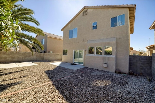 7836 Pinnochio Ave, Las Vegas, NV 89131 - back of house with stucco siding, a fenced backyard, and a patio area