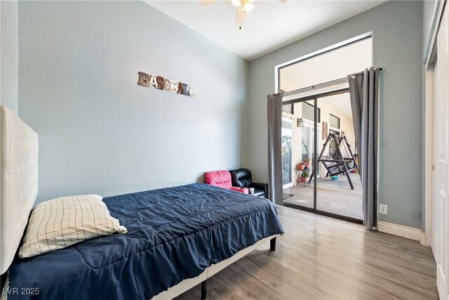 3360 National Ave, Pahrump, NV 89048 - bedroom featuring access to outside, wood finished floors, baseboards, and ceiling fan
