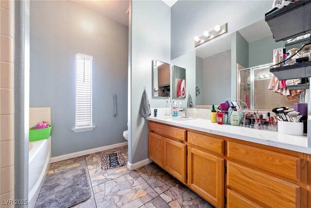 3360 National Ave, Pahrump, NV 89048 - bathroom featuring a stall shower, vanity, toilet, a garden tub, and stone finish flooring
