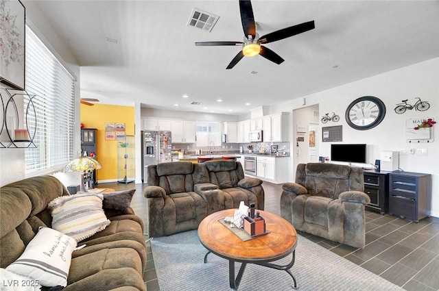 1120 Via Della Curia, Henderson, NV 89011 - living room featuring a ceiling fan, baseboards, and recessed lighting