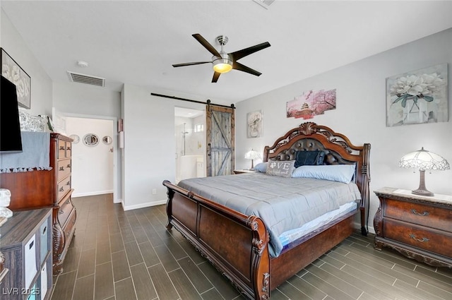 1120 Via Della Curia, Henderson, NV 89011 - bedroom with a barn door, dark wood-style floors, baseboards, and ceiling fan