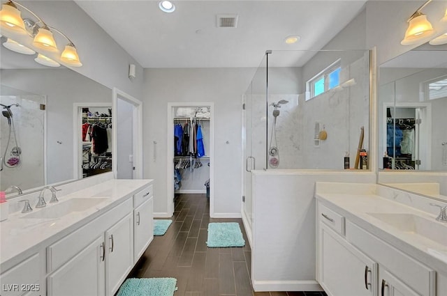 1120 Via Della Curia, Henderson, NV 89011 - full bath featuring two vanities, a walk in closet, a stall shower, and recessed lighting