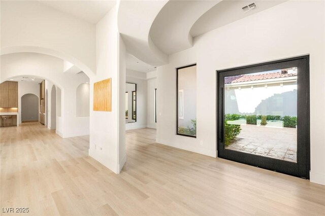 8895 S Tenaya Way, Las Vegas, NV 89113 - entrance foyer with arched walkways and light wood-style floors
