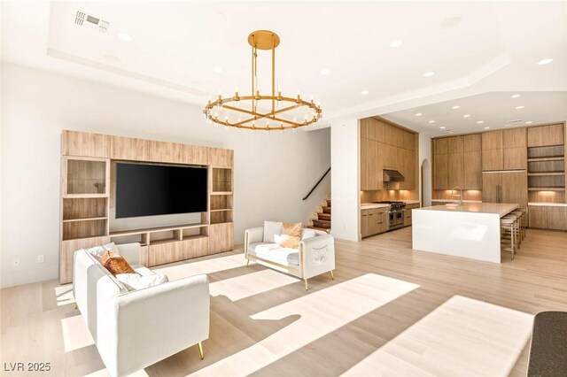 8895 S Tenaya Way, Las Vegas, NV 89113 - living area featuring light wood-style floors, recessed lighting, a chandelier, and stairs