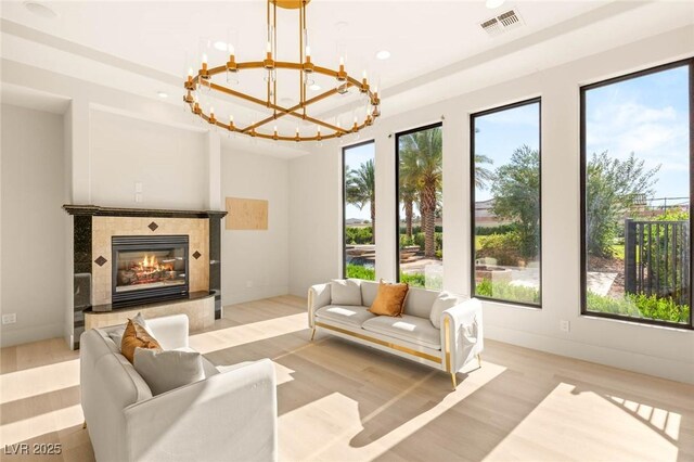8895 S Tenaya Way, Las Vegas, NV 89113 - living area featuring wood finished floors, a chandelier, recessed lighting, and a tiled fireplace