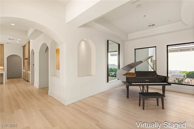 8895 S Tenaya Way, Las Vegas, NV 89113 - sitting room with a raised ceiling, light wood finished floors, arched walkways, and recessed lighting