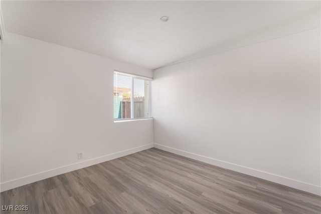 3200 E Owens Ave, North Las Vegas, NV 89030 - unfurnished room featuring lofted ceiling, wood finished floors, and baseboards