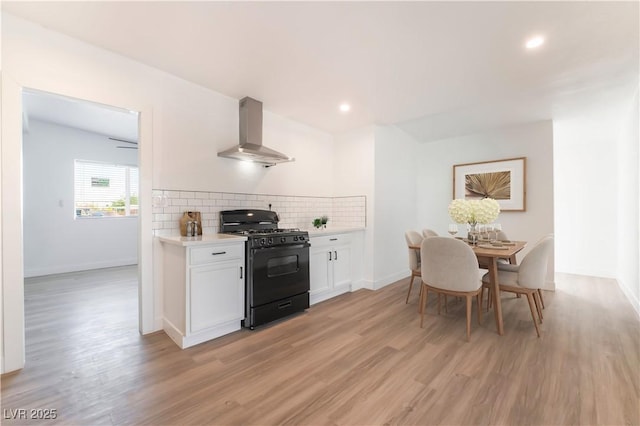 3200 E Owens Ave, North Las Vegas, NV 89030 - kitchen featuring island range hood, black gas range oven, light countertops, light wood finished floors, and recessed lighting