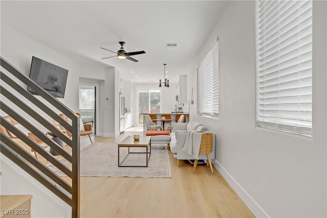 305 Napa Hills Dr, Las Vegas, NV 89144 - living room with stairs, light wood-type flooring, and a ceiling fan