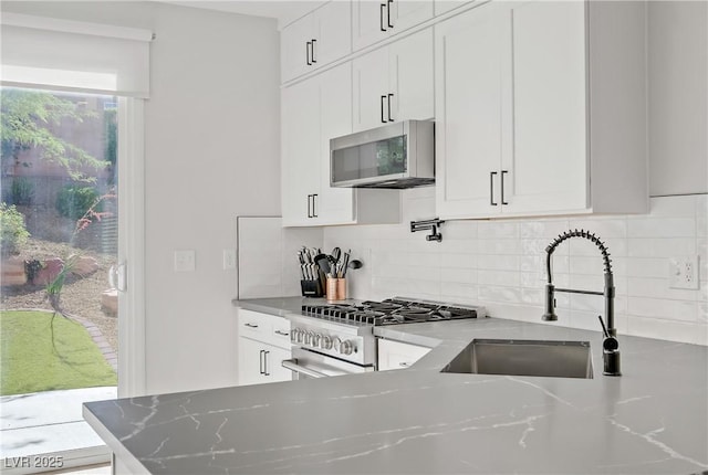 305 Napa Hills Dr, Las Vegas, NV 89144 - kitchen featuring appliances with stainless steel finishes, decorative backsplash, and white cabinets