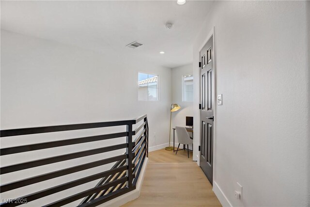305 Napa Hills Dr, Las Vegas, NV 89144 - hall with recessed lighting, light wood-style flooring, and an upstairs landing