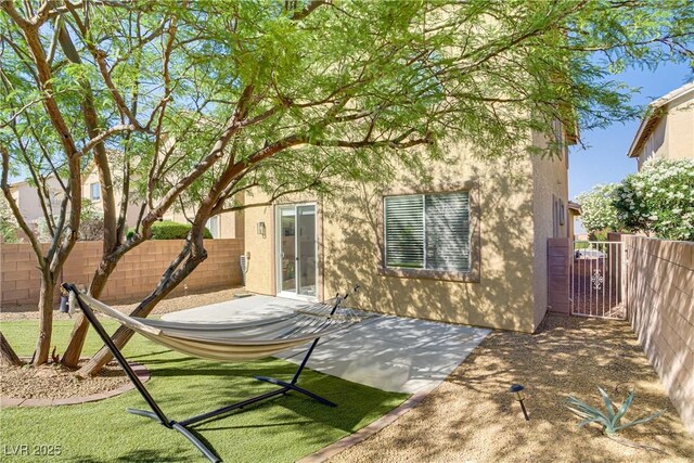 305 Napa Hills Dr, Las Vegas, NV 89144 - rear view of house featuring stucco siding, a fenced backyard, and a patio area