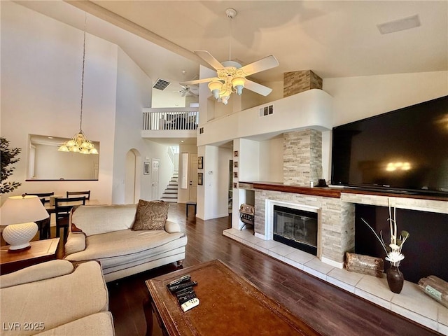 1704 Cordoba Canyon St, Las Vegas, NV 89117 - living area with wood finished floors, stairway, high vaulted ceiling, a ceiling fan, and a stone fireplace
