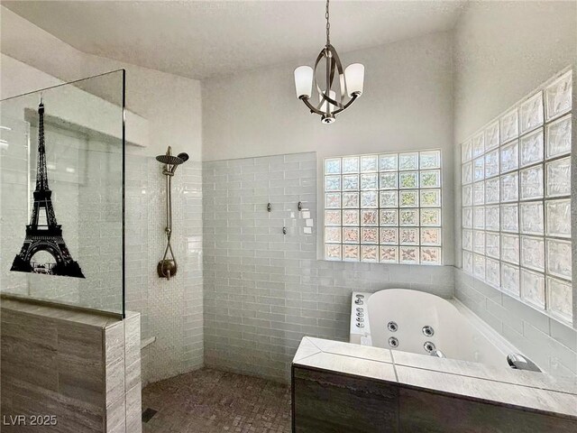 1704 Cordoba Canyon St, Las Vegas, NV 89117 - bathroom with a walk in shower, a tub with jets, tile walls, and a chandelier