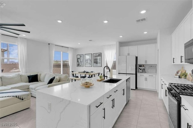 10292 Fragrant Apple Ct, Las Vegas, NV 89141 - kitchen with appliances with stainless steel finishes, a sink, open floor plan, light tile patterned flooring, and recessed lighting