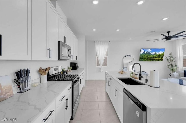 10292 Fragrant Apple Ct, Las Vegas, NV 89141 - kitchen featuring appliances with stainless steel finishes, a sink, white cabinets, recessed lighting, and a kitchen island with sink