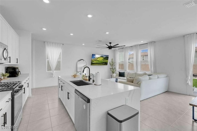 10292 Fragrant Apple Ct, Las Vegas, NV 89141 - kitchen with appliances with stainless steel finishes, a sink, light tile patterned floors, a ceiling fan, and recessed lighting