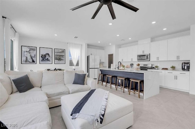 10292 Fragrant Apple Ct, Las Vegas, NV 89141 - living area featuring ceiling fan, recessed lighting, and light tile patterned floors