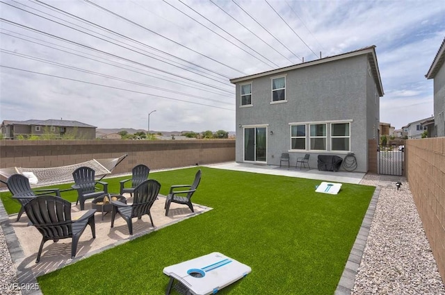 10292 Fragrant Apple Ct, Las Vegas, NV 89141 - rear view of house featuring a patio area, stucco siding, an outdoor fire pit, and a gate
