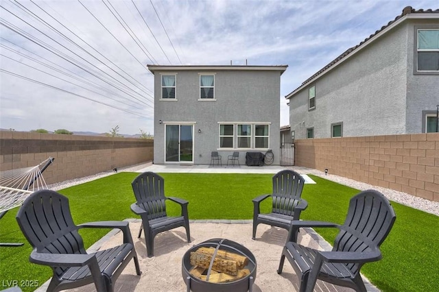 10292 Fragrant Apple Ct, Las Vegas, NV 89141 - back of property with a fire pit, a patio area, and stucco siding