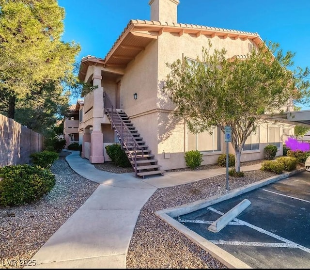 8450 Alta Dr Unit 204, Las Vegas, NV 89145 - view of building exterior featuring uncovered parking and stairway