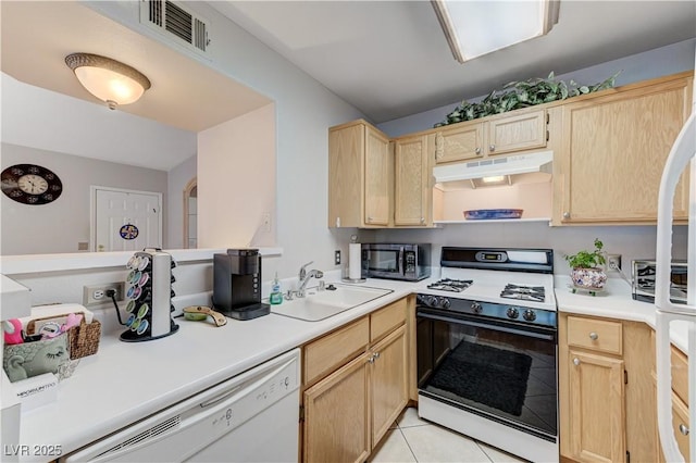 8450 Alta Dr Unit 204, Las Vegas, NV 89145 - kitchen with gas stove, light brown cabinetry, stainless steel microwave, under cabinet range hood, and dishwasher