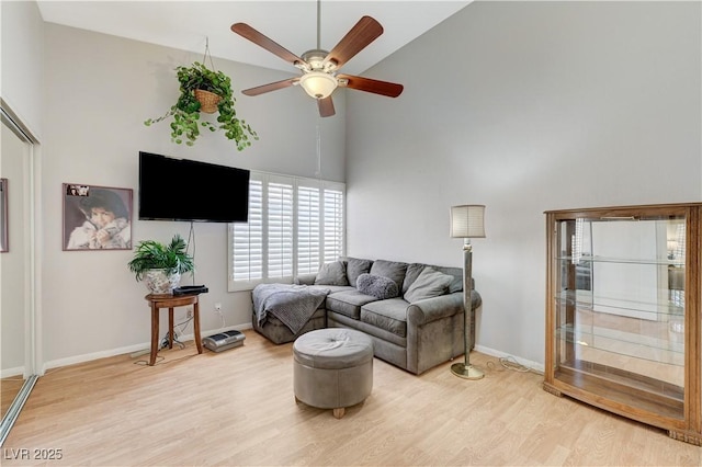8450 Alta Dr Unit 204, Las Vegas, NV 89145 - living room with high vaulted ceiling, a ceiling fan, light wood-style floors, and baseboards