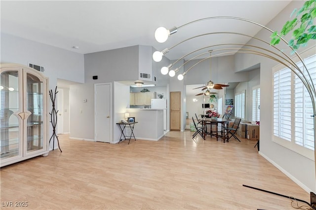 8450 Alta Dr Unit 204, Las Vegas, NV 89145 - kitchen featuring a ceiling fan, high vaulted ceiling, light wood finished floors, and baseboards