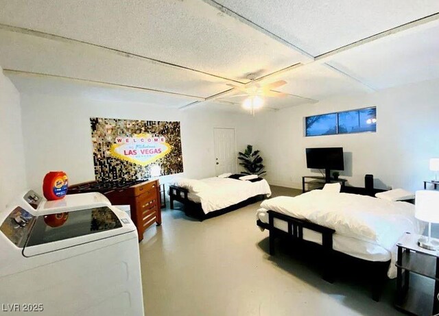 6320 Shawnee Ave, Las Vegas, NV 89107 - bedroom featuring washer / dryer, concrete flooring, and ceiling fan