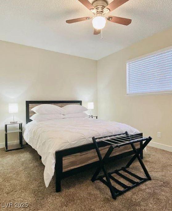 6320 Shawnee Ave, Las Vegas, NV 89107 - carpeted bedroom featuring a textured ceiling, baseboards, and ceiling fan