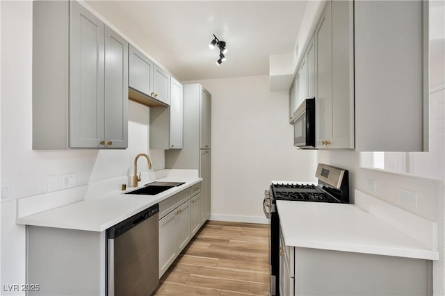 3318 N Decatur Blvd Unit 1107, Las Vegas, NV 89130 - kitchen featuring stainless steel appliances, a sink, light wood finished floors, and gray cabinets