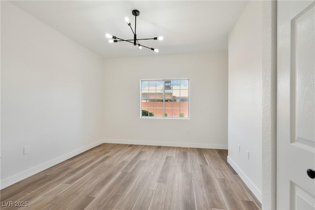 3318 N Decatur Blvd Unit 1107, Las Vegas, NV 89130 - unfurnished room with a chandelier, light wood finished floors, and baseboards