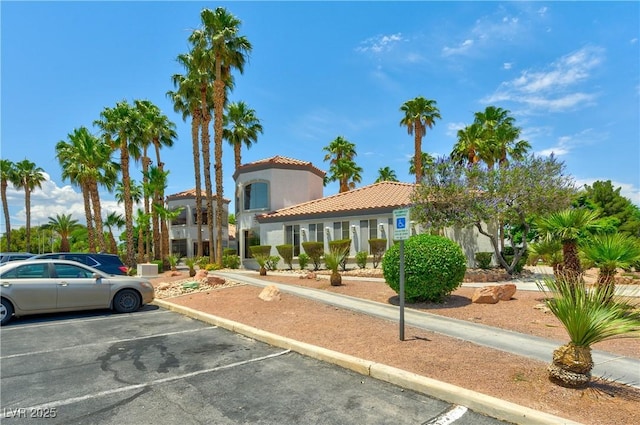 3318 N Decatur Blvd Unit 1107, Las Vegas, NV 89130 - view of front facade with a tile roof, uncovered parking, and stucco siding