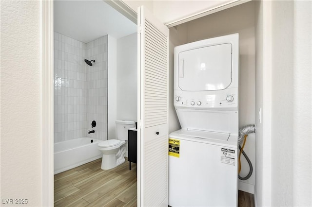 3318 N Decatur Blvd Unit 1107, Las Vegas, NV 89130 - full bathroom featuring estacked washer and dryer, toilet, wood finished floors, and shower / bathtub combination