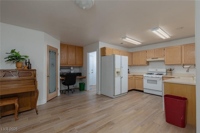 1835 Banaba Ln, Las Vegas, NV 89156 - kitchen with white appliances, a sink, light countertops, light wood-style floors, and an office area