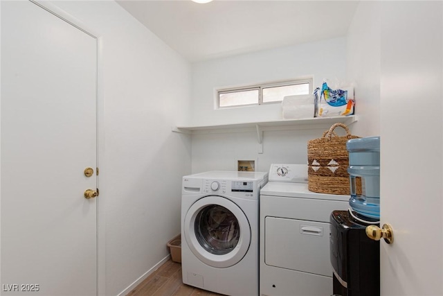 1835 Banaba Ln, Las Vegas, NV 89156 - laundry room with washer and dryer, light wood-style flooring, and baseboards