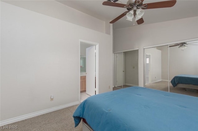 1835 Banaba Ln, Las Vegas, NV 89156 - bedroom with light carpet, two closets, baseboards, ensuite bath, and a ceiling fan
