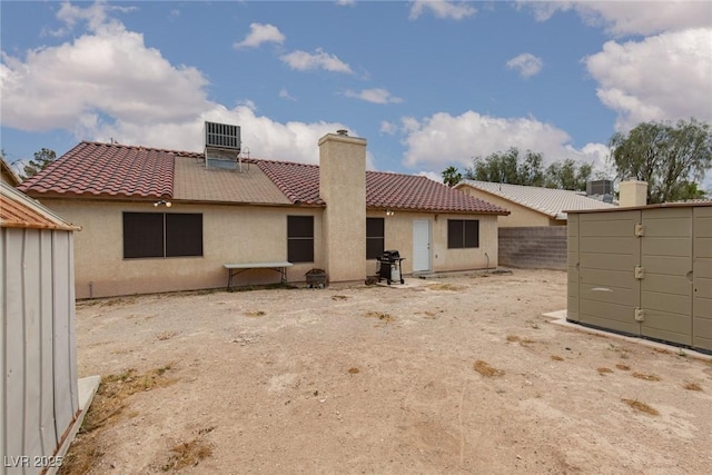1835 Banaba Ln, Las Vegas, NV 89156 - back of property featuring a tile roof, stucco siding, and a chimney