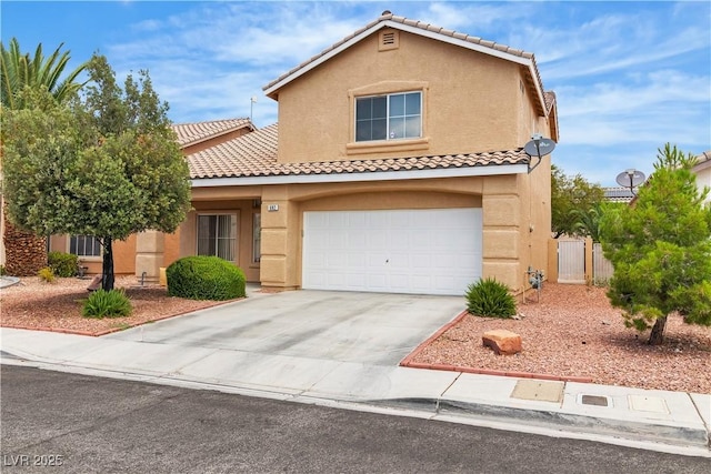 682 E Sole Addiction Ave, Las Vegas, NV 89183 - view of front of house with stucco siding, a tile roof, concrete driveway, a gate, and an attached garage