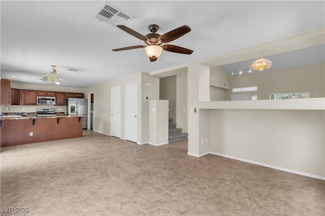 682 E Sole Addiction Ave, Las Vegas, NV 89183 - unfurnished living room with stairs, ceiling fan, a sink, and baseboards