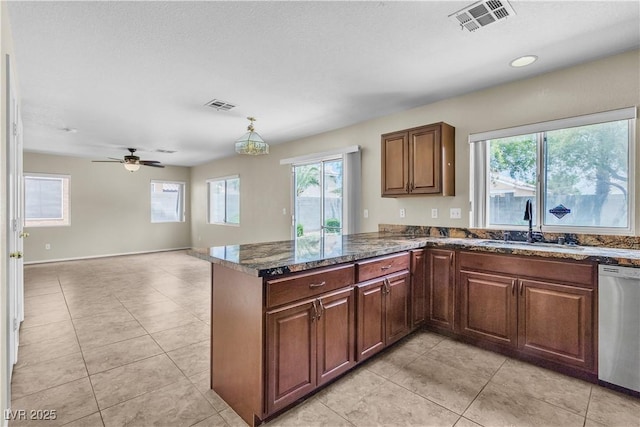 682 E Sole Addiction Ave, Las Vegas, NV 89183 - kitchen featuring stainless steel dishwasher, a sink, a ceiling fan, a peninsula, and light tile patterned floors