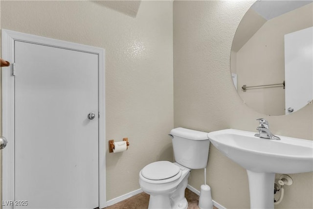 682 E Sole Addiction Ave, Las Vegas, NV 89183 - half bath with toilet, baseboards, tile patterned floors, and a sink