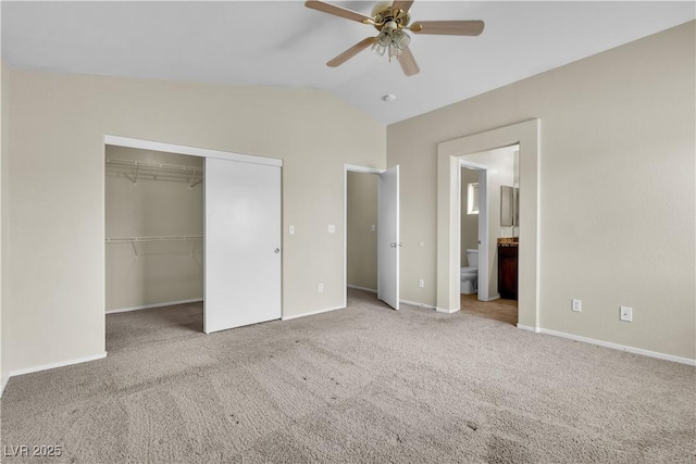 682 E Sole Addiction Ave, Las Vegas, NV 89183 - unfurnished bedroom featuring carpet flooring, a closet, vaulted ceiling, baseboards, and ensuite bathroom