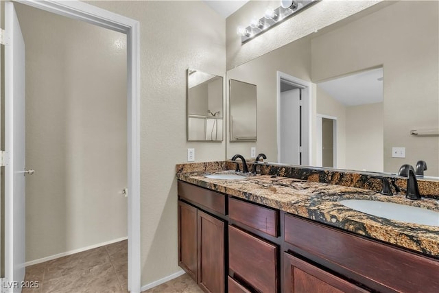 682 E Sole Addiction Ave, Las Vegas, NV 89183 - bathroom featuring double vanity, tile patterned floors, and baseboards