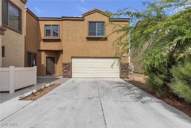 6325 Orions Tool St, North Las Vegas, NV 89031 - view of front facade featuring concrete driveway, a garage, stucco siding, and stone siding