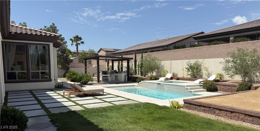 5855 Boulder Brook Ct, Las Vegas, NV 89149 - view of pool with exterior kitchen, an in-ground hot tub, a patio, and a fenced backyard