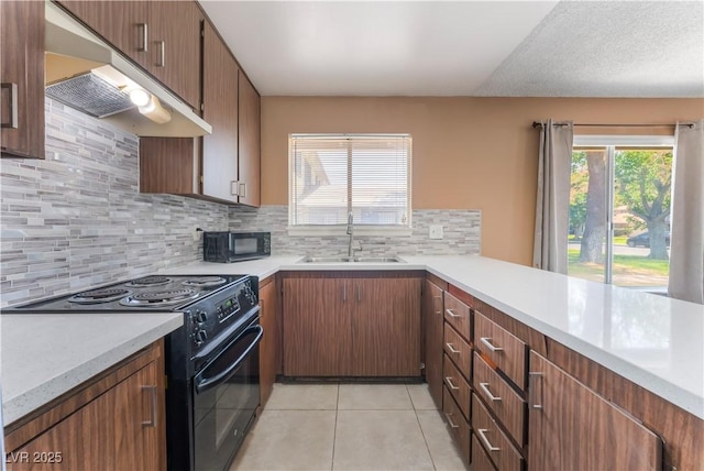 1470 Elizabeth Ave Unit 1, Las Vegas, NV 89119 - kitchen with black appliances, a sink, light countertops, and light tile patterned flooring