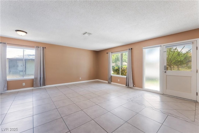 1470 Elizabeth Ave Unit 1, Las Vegas, NV 89119 - spare room featuring a textured ceiling, light tile patterned floors, and baseboards