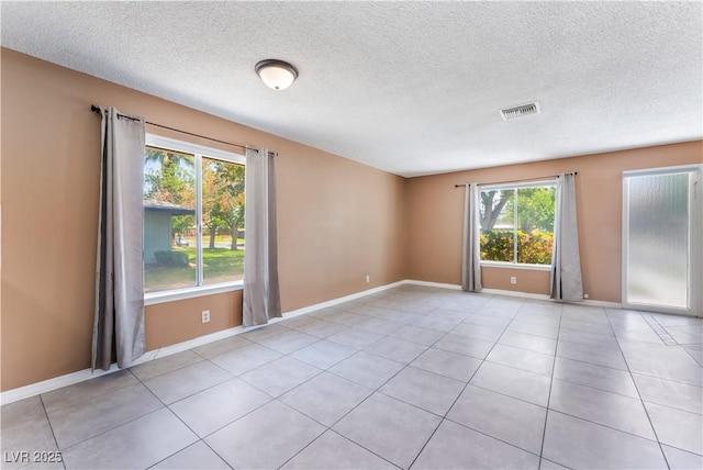 1470 Elizabeth Ave Unit 1, Las Vegas, NV 89119 - tiled empty room with a textured ceiling and baseboards