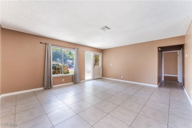 1470 Elizabeth Ave Unit 1, Las Vegas, NV 89119 - spare room with light tile patterned flooring, a textured ceiling, and baseboards